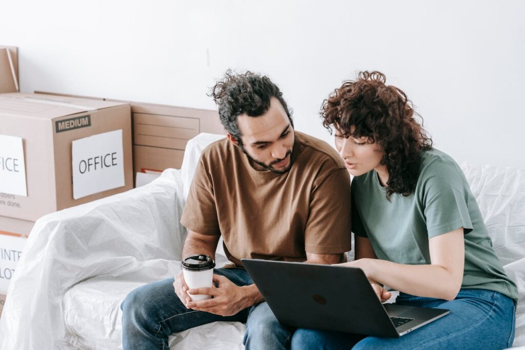 couple reading something on a laptop