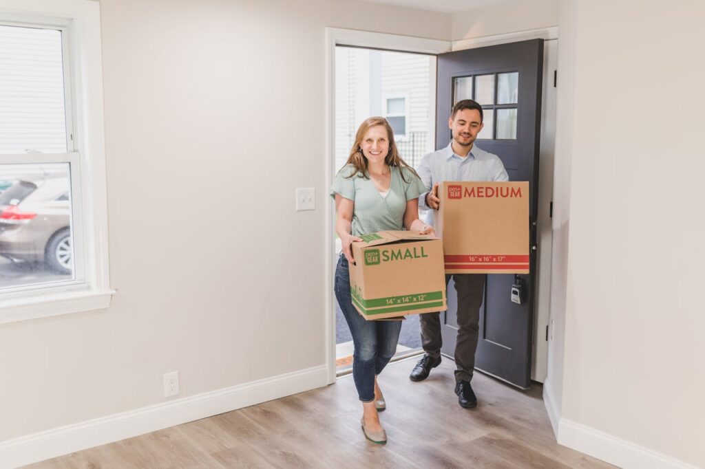 man and woman holding boxes