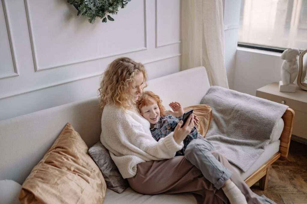 A Woman Taking a Selfie on a Couch with her Son
