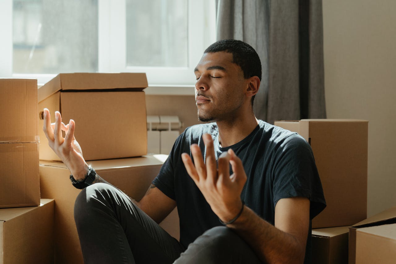 Man in Black Crew Neck T-shirt Sitting on Brown Sofa