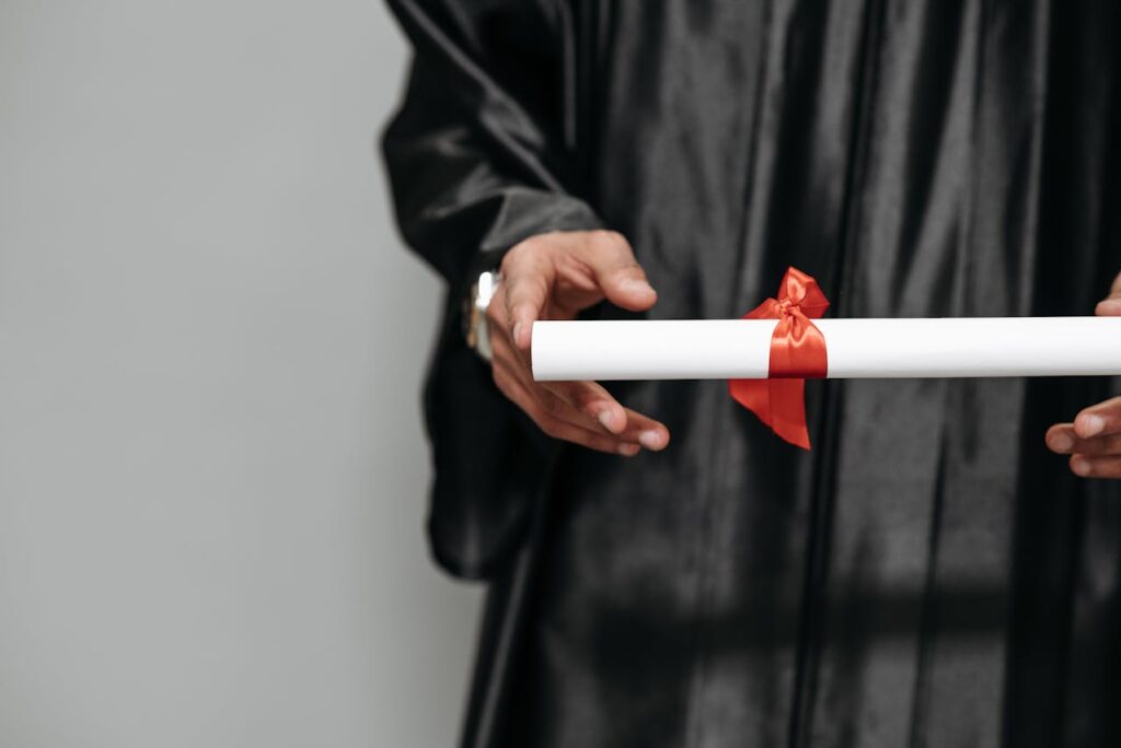 Photo of Person Holding Diploma
