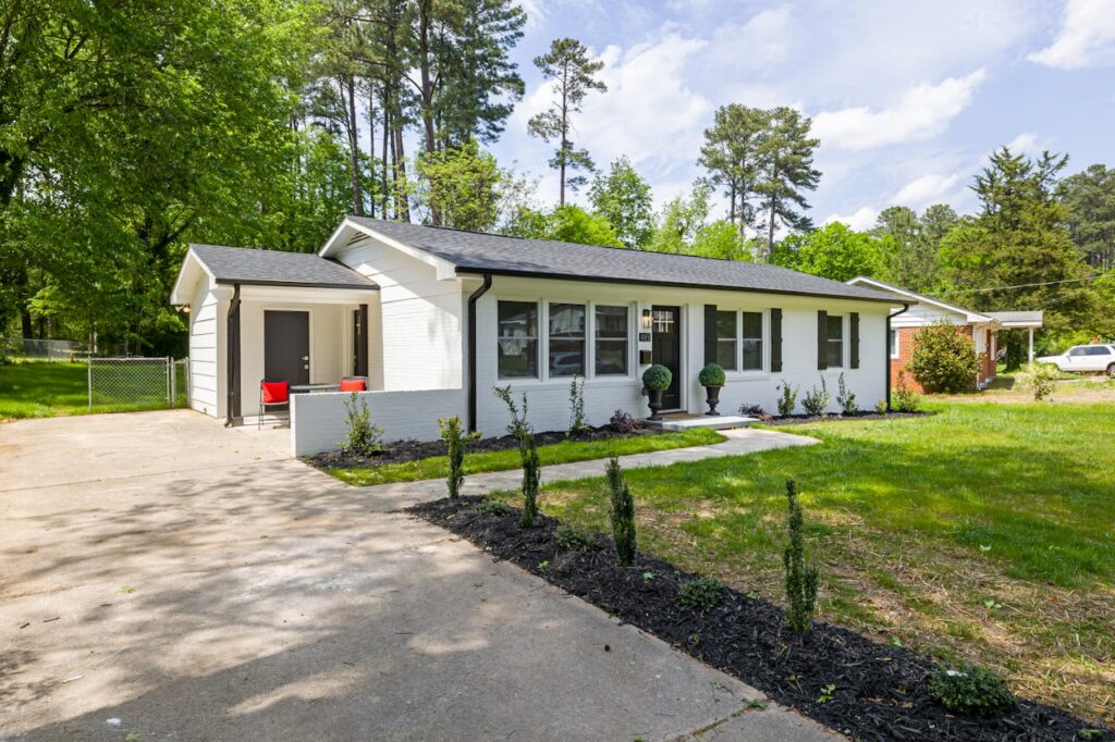 White and Gray Concrete House Near Green Trees
