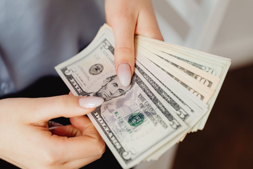 Close-Up Shot of a Person Holding Paper Money
