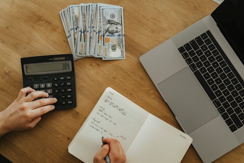 A Person Holding Black Desk Calculator

