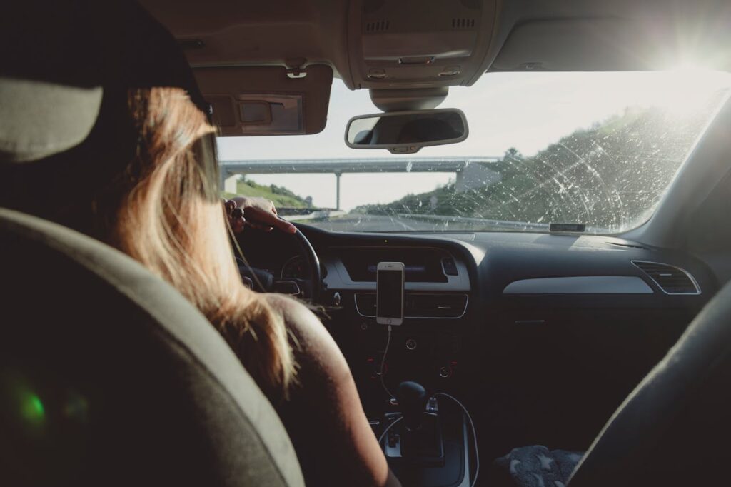 Woman Driving Car On Freeway
