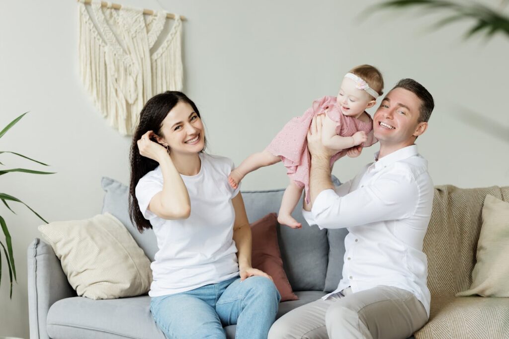 Photo of a Couple Sitting With a Baby after moving from Chesapeake to Norfolk