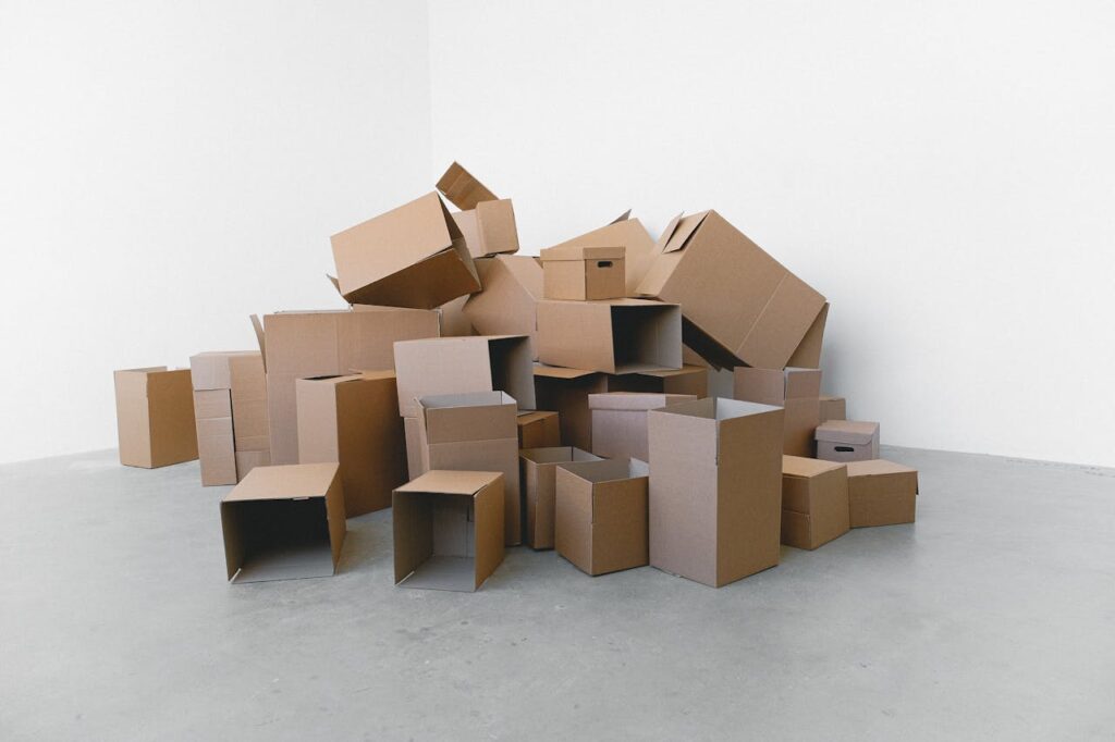 Stack of carton boxes on floor in rented house