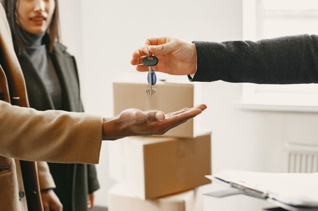 Person Giving Keys from New Home to Family