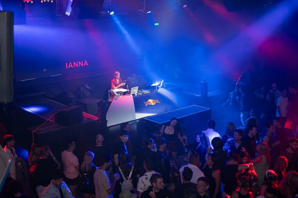 A dj is playing music at a nightclub in one of the best nightlife cities in the USA
