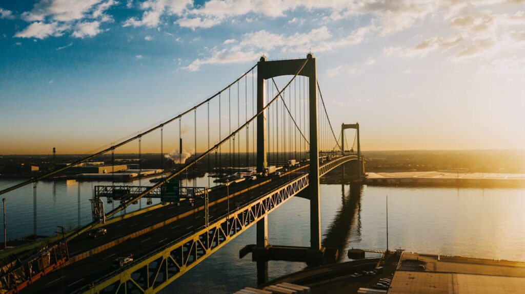 Majestic suspension bridge over river in bright sunshine