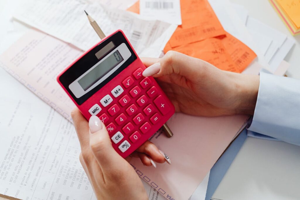 A Close-Up Shot of a Person Using a Calculator