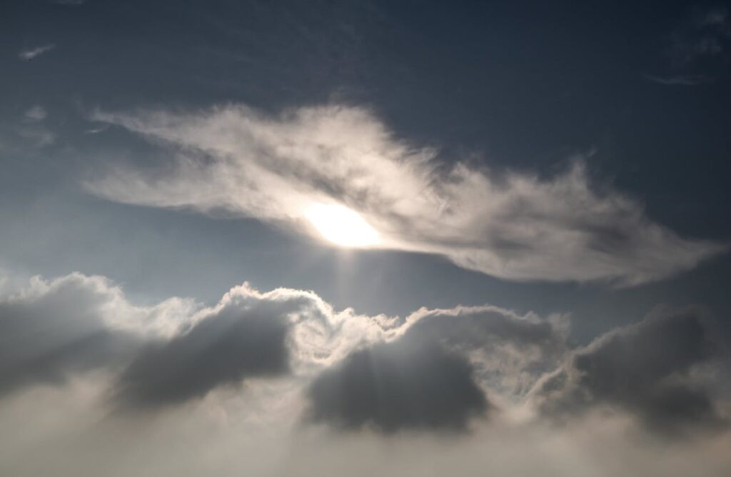 Serene Sky with Sunlight Breaking Through Clouds