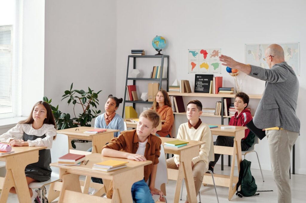 Children Sitting on Chair in Front of Table