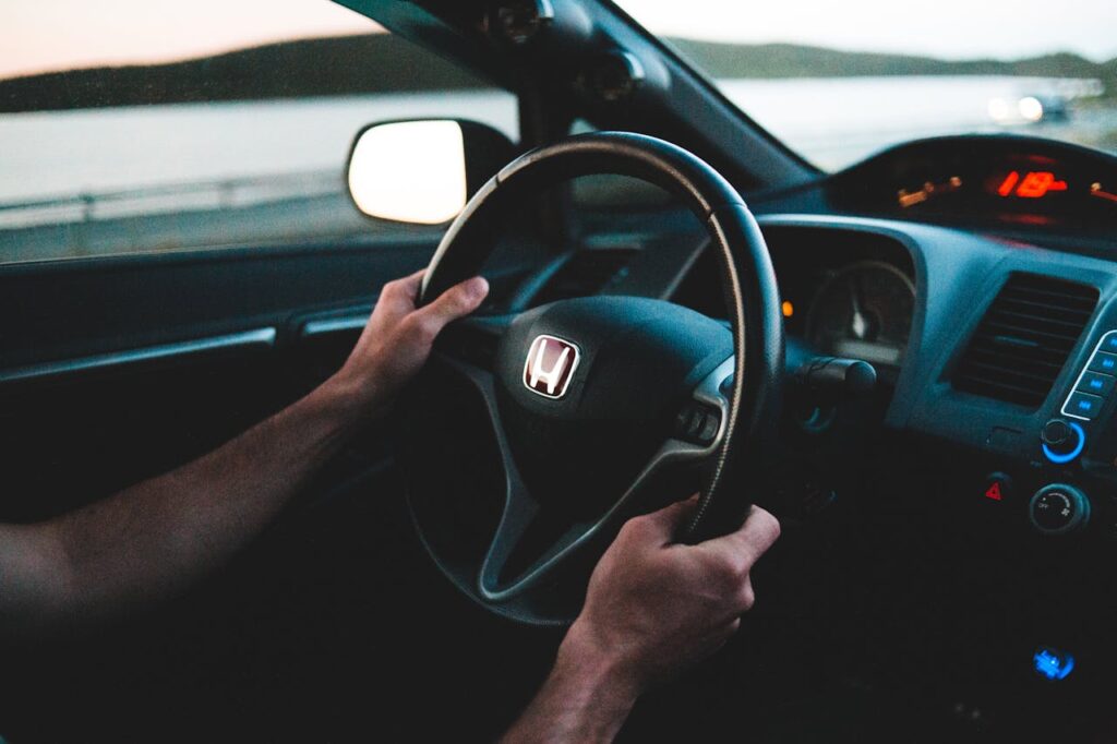 Crop driver driving modern car near river