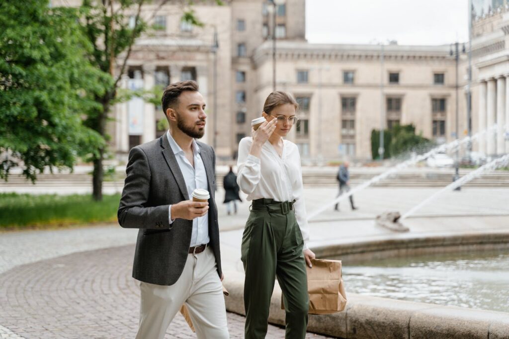 Man and Woman Walking Near the Fountain