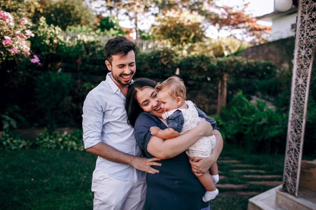 Happy Family Embracing in Lush Garden