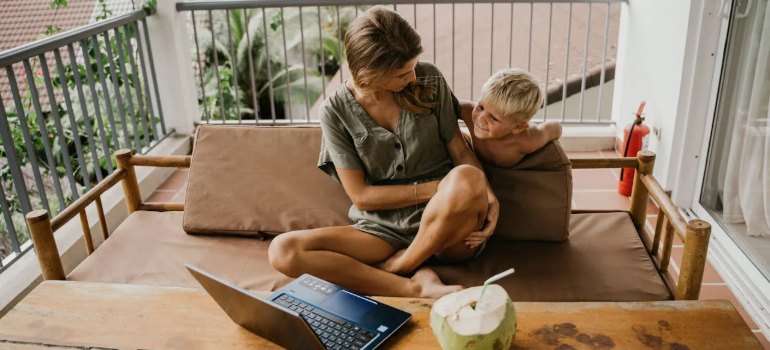 A mother and son sitting together on a sofa in their living room